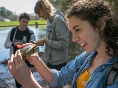 student holding a turtle